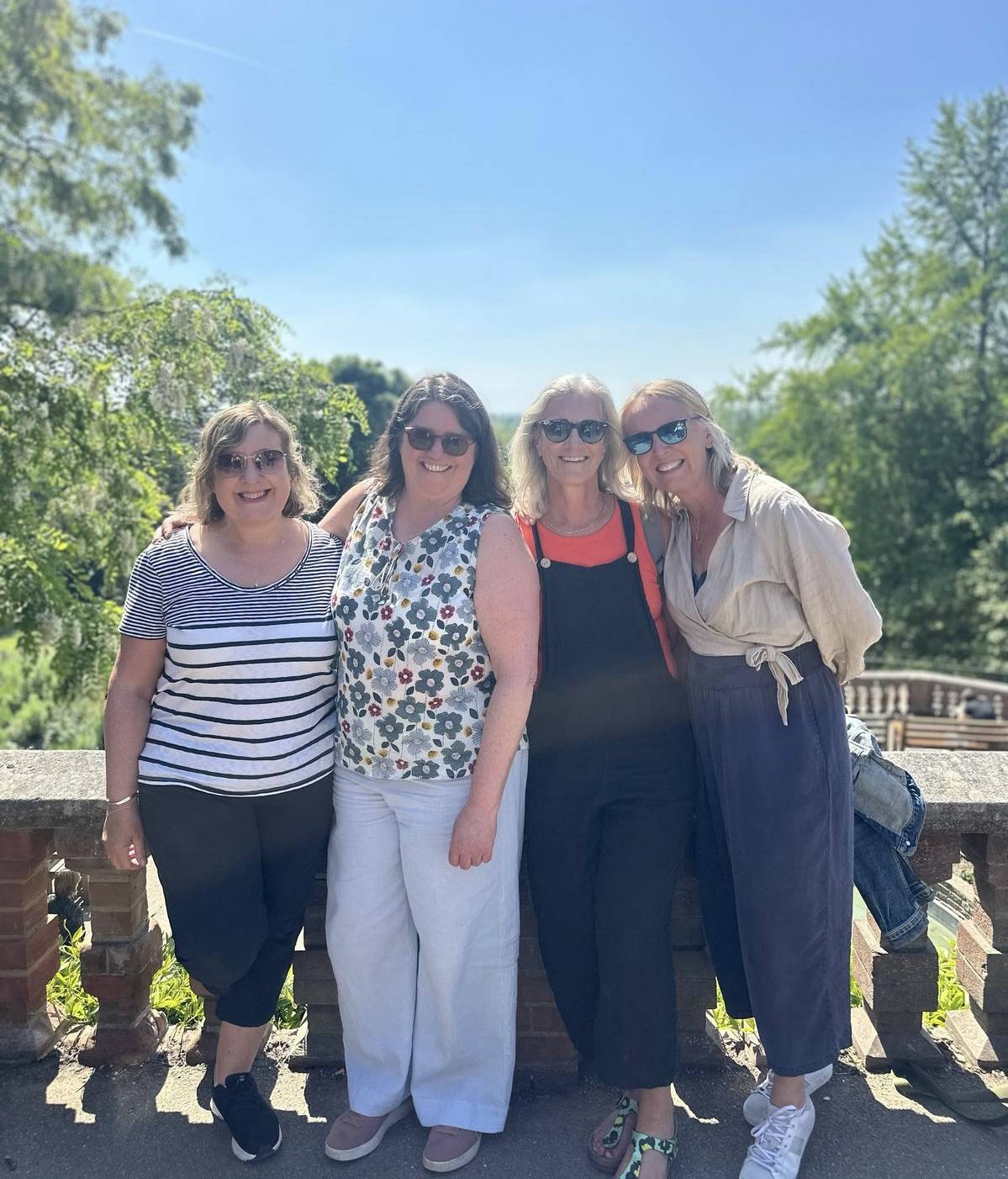 Image of four friends in the sunshine enjoying a day out